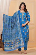 Woman wearing a bright blue handblock printed cotton kurta set with a coordinated Kota Doriya dupatta featuring floral motifs.