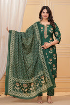 Model posing in a dark green handblock printed straight kurta with an embroidered neck, matching printed pants, and a heavily bordered Chanderi dupatta.