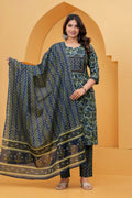A woman posing in a navy blue handblock printed cotton kurta with floral patterns, featuring matching zigzag pants and a printed dupatta.