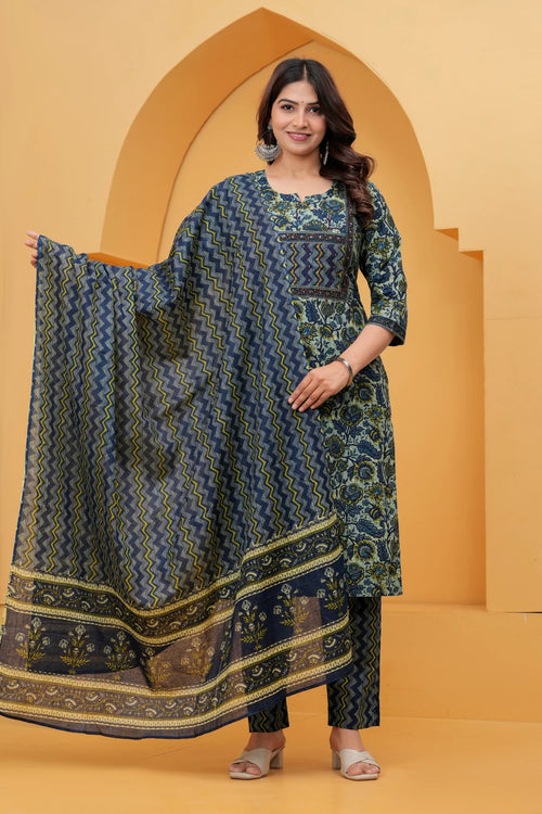 A woman posing in a navy blue handblock printed cotton kurta with floral patterns, featuring matching zigzag pants and a printed dupatta.
