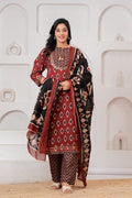 Woman wearing a maroon and black Ikat print cotton kurta set with a matching black dupatta and chevron trousers.
