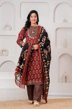 Woman wearing a maroon and black Ikat print cotton kurta set with a matching black dupatta and chevron trousers.